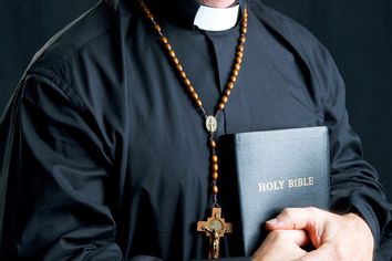 Priest With Rosary and Bible