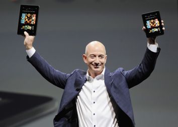 Amazon CEO Bezos holds up the new Kindle Fire HD 7