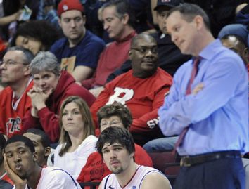 Rutgers players Jack and Biruta look on as Rutgers coach Mike Rice paces in Piscataway