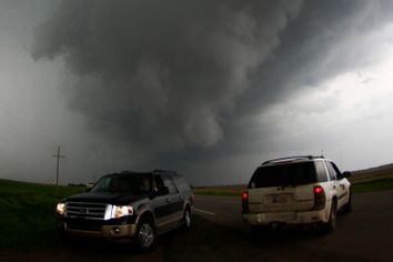 Storm chasers get close to a tornadic thunderstorm, one of several tornadoes that touched down, in South Haven