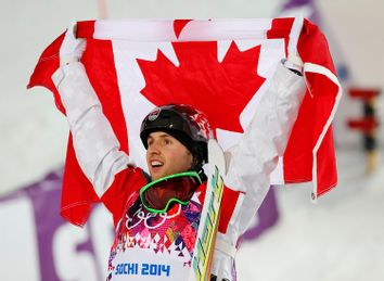 Winner Canada's Bilodeau celebrates after the men's freestyle skiing moguls finals at the 2014 Sochi Winter Olympic Games in Rosa Khutor