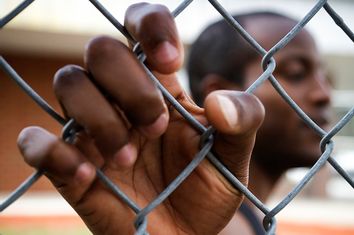 Man Behind Fence