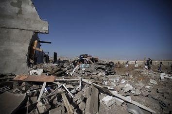 People gather at the site of a Saudi-led air strike in Yemen's capital Sanaa