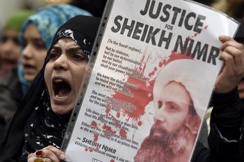Protester holds a placard during a demonstration against the execution of Shi'ite cleric Sheikh Nimr al-Nimr in Saudi Arabia, outside the Saudi Arabian Embassy in London, Britain