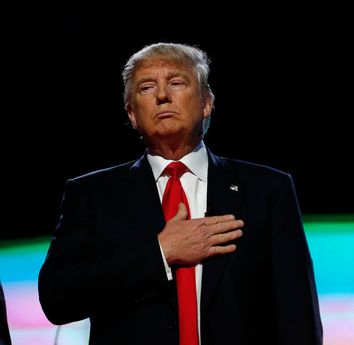 Republican U.S. presidential candidates put their hands over their hearts for the U.S. National Antherm as they stand together onstage at the start of the Republican U.S. presidential candidates debate sponsored by CNN at the University of Miami in Miami