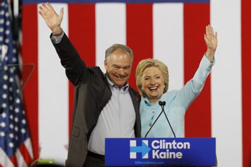 Democratic U.S. vice presidential candidate Kaine waves with his presidential running-mate Clinton after she introduced him during a campaign rally in Miami