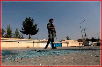 An Afghan policeman stands guard after an attack at the American University of Afghanistan in Kabul