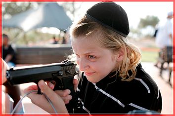 A boy plays with a gun during an 