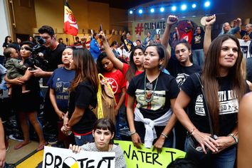 Attendees stand together during a climate change rally in solidarity with protests of the pipeline in North Dakota at MacArthur Park in Los Angeles, California