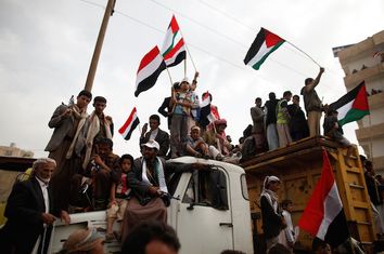 Supporters of the Houthi movement stand atop a truck as they demonstrate to mark the annual Al-Quds Day, in Sanaa