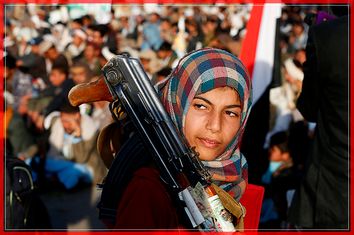 A girl carries a rifle as she attends a rally by followers of the Shi'ite Houthi movement commemorating the death of Imam Zaid bin Ali in Sanaa, Yemen