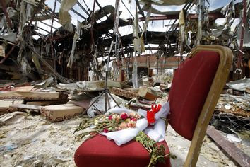 Flowers are seen on a chair during a visit by human rights activists to a community hall that was struck by an air strike during a funeral on October 8, in Sanaa