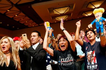 Donald Trump supporters cheer as U.S. presidential election results are announced during a Republican watch party in Phoenix