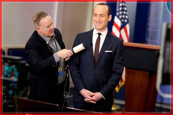 White House Press Secretary Spicer removes lint from Senior White House Advisor Miller's jacket as he waits to go on the air in the White House Briefing Room in Washington.