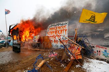 A structure burns after being set alight by protesters preparing to evacuate the main opposition camp against the Dakota Access oil pipeline near Cannon Ball