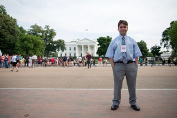 Kyle Mazza stands for a portrait in front of the White House.