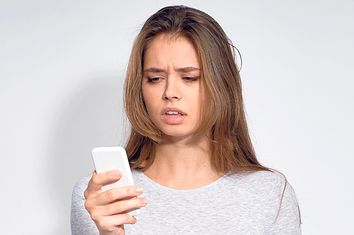 Confused Woman Looking at Phone