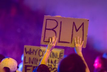 A protester holds a Black Lives Matter placard