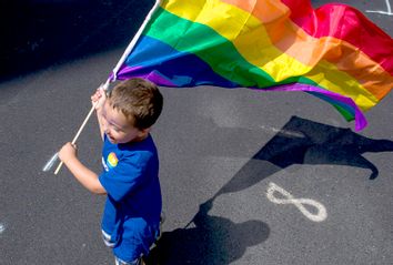 A boy carries a flag during the New York City Pride