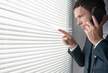 Man looking out window