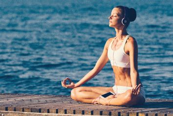 Woman Meditating Using Phone