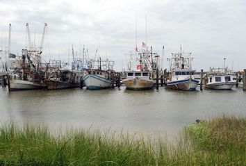 Idle fishing boats sit at the docks May