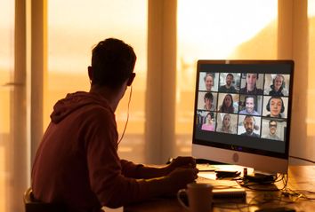 Young man distracted while on video call from his home during lockdown