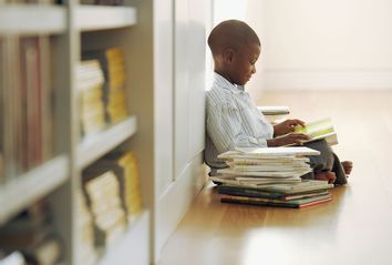 Young boy with a stack of storybooks