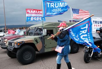 Supporters of President Donald Trump participate in a car and motorcycle rally