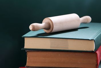 Stack Of Books With Rolling Pin