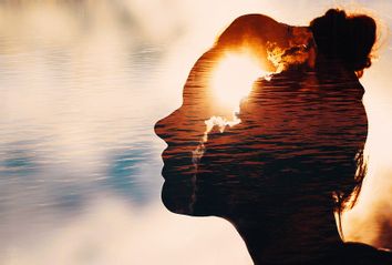 un peeks out from behind the clouds in woman's head.