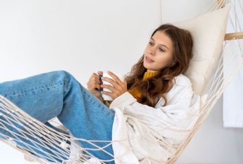 Woman drinking hot beverage and enjoying morning