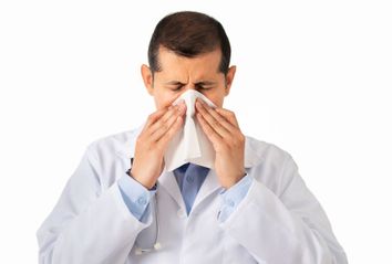 Doctor blowing his nose