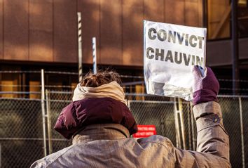 A woman protests outside the Hennepin County Government Center, where the trial of former police officer Derek Chauvin is being held