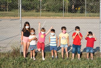 Children playing in the park in face masks