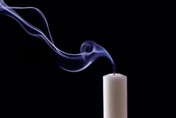 Smoke trailing from extinguished candle