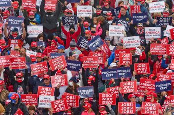 Supporters of then-President Donald Trump hold signs at a rally in Pennsylvania.