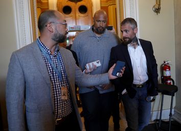 Metropolitan Police Officer Michael Fanone (R) answers questions while leaving the office of House Minority Leader Kevin McCarthy (R-CA), with U.S. Capitol Police Officer Harry Dunn (C) at the U.S. Capitol on June 25, 2021