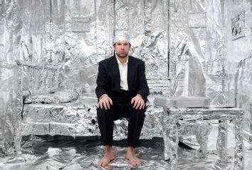Man in tinfoil hat and tinfoil-lined bedroom