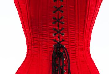 The back of a red corset with black laces