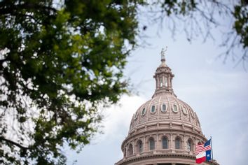 The U.S. and Texas flags wave outside the Texas Capitol on July 13, 2021 in Austin, Texas. 