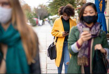 People commuting in the city wearing face masks