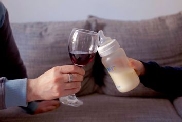 Father And Son Toasting Wineglass And Milk Bottle