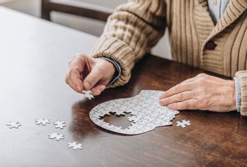 Senior man playing with puzzle