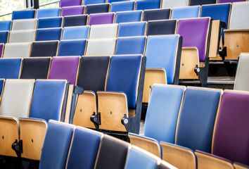  unoccupied seats in an empty lecture hall