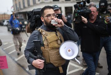 A demonstrator armed with an AR-15 style weapon protests outside of the Kenosha County Courthouse