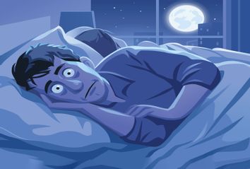 Man lying in his bed, trying to sleep