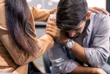 Woman consoling man