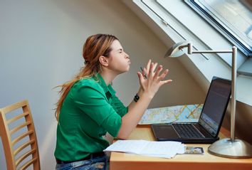 Woman working from home, feeling angry