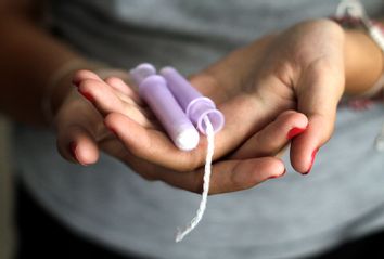 Close-Up Of Woman Hand Holding Tampons